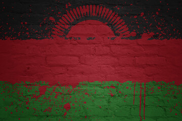 colorful painted big national flag of malawi on a massive brick wall