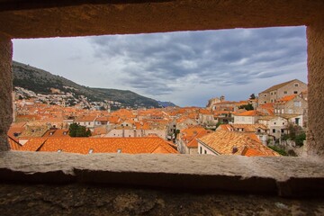 View through the fort window to the rooftop of Old town in Dubrovnik, Dalmatia, Croatia.