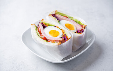 Japanese Wanpaku sandwich with egg, red cabbage and ham