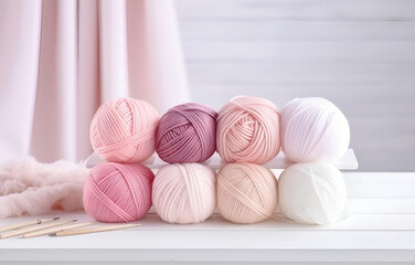Fototapeta na wymiar colorful balls of thread and metal knitting needles on a white w