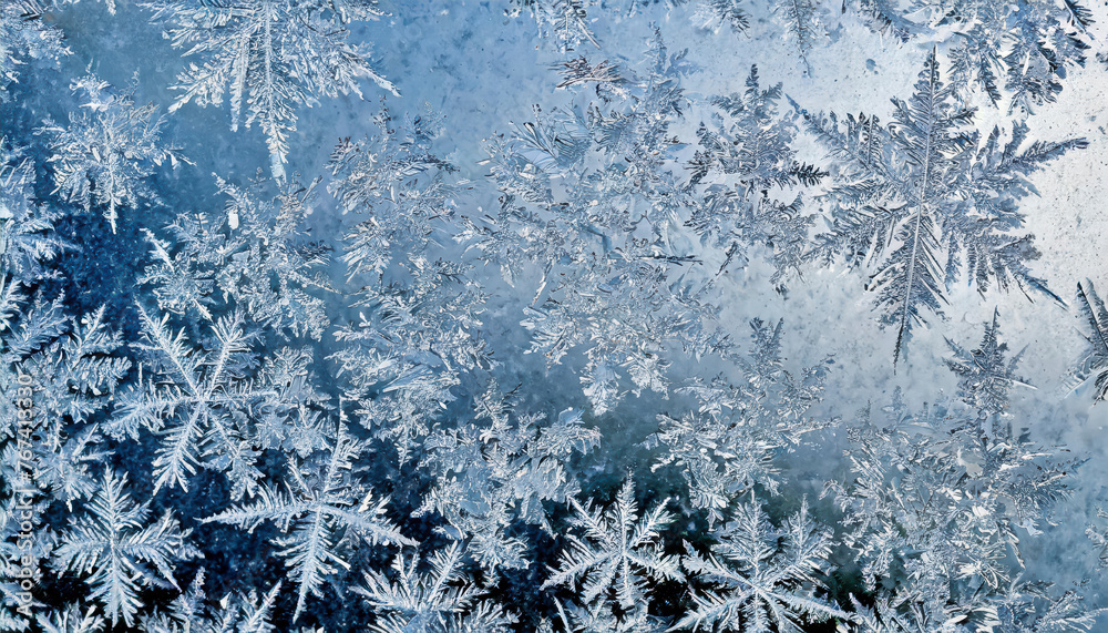 Poster a close up of snowflakes on a blue background. the snowflakes are all different shapes and sizes, an