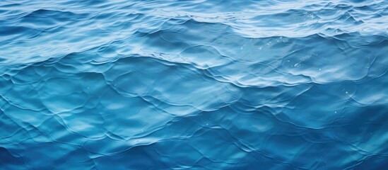 Fototapeta premium A close-up view of a small boat sailing on the gentle waves of a vast blue ocean