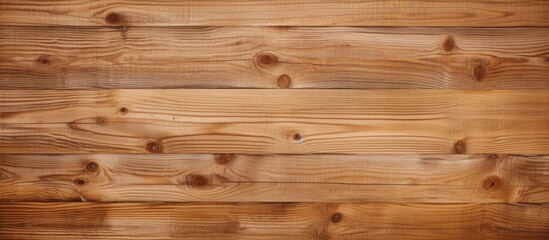 Fototapeta premium A closeup of a hardwood plank flooring with a rich amber wood stain and varnish, showcasing the intricate pattern of the brown wooden wall in the background