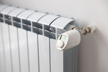 White heating battery and electronic, smart temperature regulator. warmth in the room and the house. preparation for spring and winter. energy saving