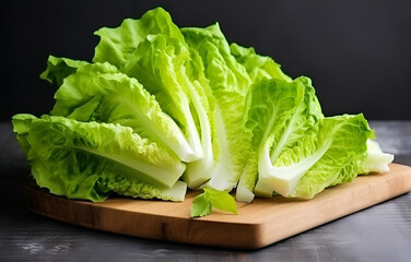 fresh lettuce vegetables cut raw on wooden plate on white table