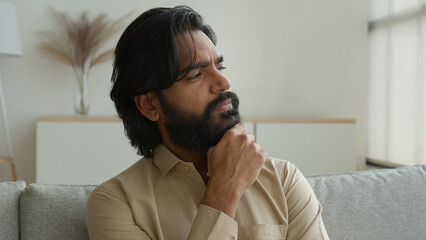 Thoughtful man Arabian muslim guy think idea indian male homeowner looking away dreaming thinking...