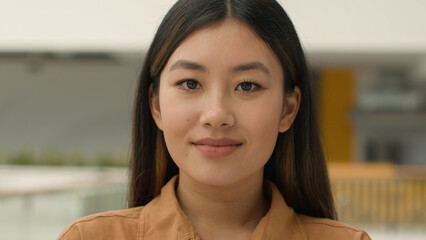 Close up business portrait Asian ethnic girl beautiful calm chinese korean japanese woman looking...