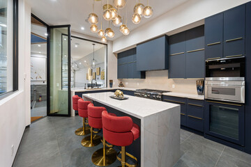 Contemporary kitchen with  blue cabinets and a marble countertop