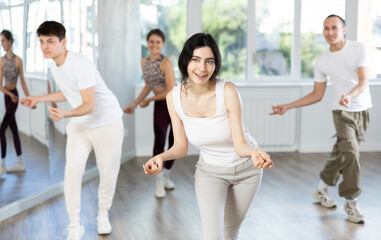 Girl, together with dance youth group, rehearses performance, works out succession of events...