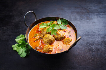 Traditional spicy Indian meat balls curry Rogan Josh with ground beef and rice served as close-up...