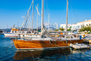 Wooden sailing yacht boat in Adamas port, Milos island, Cyclades, Greece