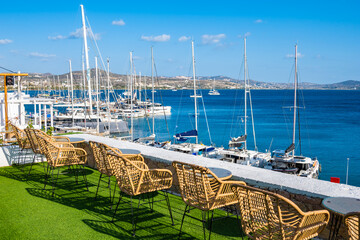 View of Adamas port with boats from terrace of restaurant bar, Milos island, Cyclades, Greece - 767422727
