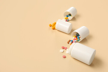 Jars with different pills on yellow background