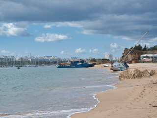 Ferragudo, Algarve, Portugal - 03 11 2024. Storm's Aftermath: Boats Stranded on Ferragudo Coastline.