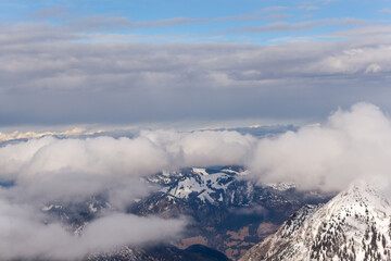 Fototapeta na wymiar Mountain landscape in the Alps - white clouds between the peaks