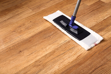 Cleaning of wooden laminate floor with mop, closeup