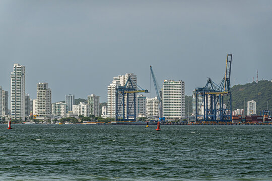 Cartagena, Colombia - July 25, 2023: Bocagrande. Looking north over bay from Fort Santa Cruz de Castillogrande. Part of container terminal and tall white buildig on mainland