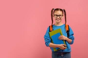 Happy student girl holding blue folders