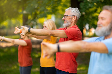 Senior adults participate in stretching exercise, extending their arms forward