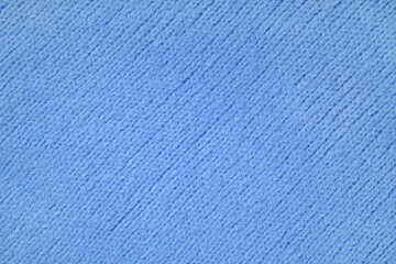 Blue knitted woolen jersey fabric with diagonal weaving, sweater, pullover texture background. Fabric abstract backdrop, cloth wallpaper