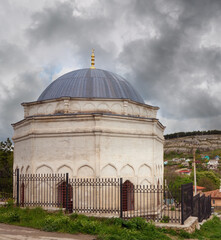 Overcast sky with storm clouds, spring view of Bakhchisaraj town and mosque in foreground (Crimea, Ukraine)