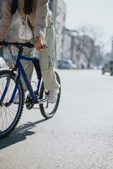 A young woman enjoys a leisurely bike ride on a bright, sunny day in an urban setting, showcasing an active lifestyle