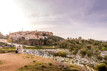 Fototapeta premium Fez, Morocco - March 17, 2024: Green Hill and muslim tombs viewed from Borj Nord Area, The ancient city of Fez, The oldest capital of Morocco