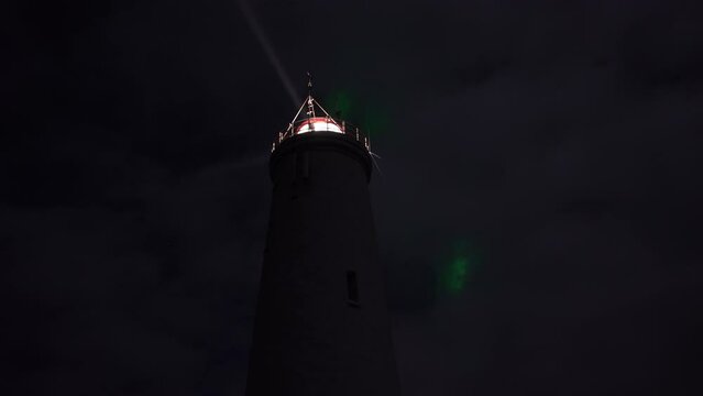 Reykjanesviti lighthouse Iceland aurora borealis and airplane through clouds
