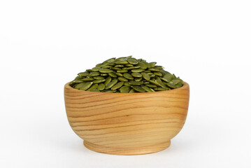 pumpkin seeds in a small wooden cup