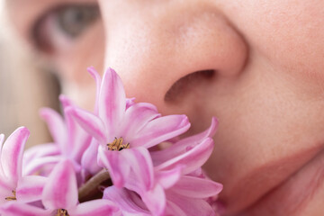 close-up Female face lights up with delight savors sweet scent hyacinth, capturing joy of...
