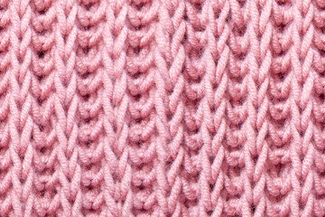 pink beautiful knitted braid pattern of light natural wool yarn, seamless knitted texture, concept warm things for cold weather, knitting hobby, needlework, fashion clothes