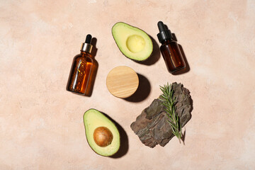 Composition with cosmetic products, avocado and tree bark on color background