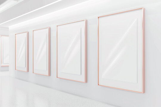 A minimalist white art gallery featuring a row of empty blank mock-up posters within slim rose gold frames. The subtle pink hue of the frames adds a touch of warmth to the space,