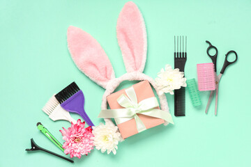 Composition with hairdresser's supplies, bunny ears and gift box on color background