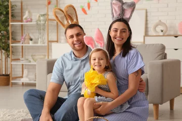 Foto op Plexiglas Happy family in bunny ears with Easter gift sitting on floor at home © Pixel-Shot