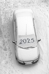 snow-covered car with the inscription 2025 - 767457356