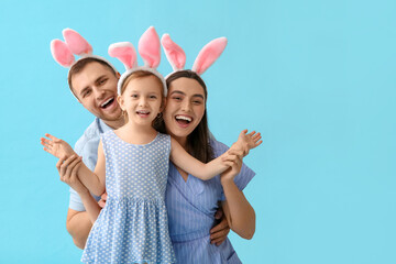 Happy family in Easter bunny ears on blue background