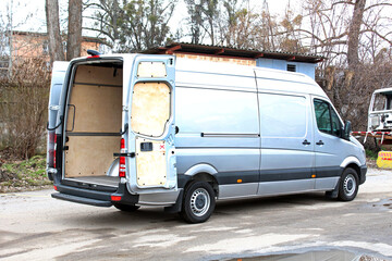 Van Cargo open trunk in the city street. Open van body. Van Cargo open door trunk. Cargo van ready...