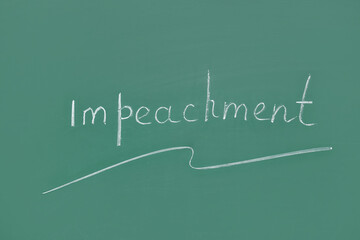 Word IMPEACHMENT written on chalkboard