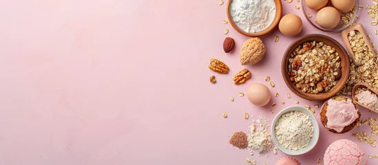Papier Peint photo autocollant Pain Food ingredients for baking arranged on a soft pink pastel background. Flat lay image with room for text. Overhead view. Baking theme. Mockup.