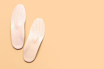 Leather orthopedic insoles on beige background