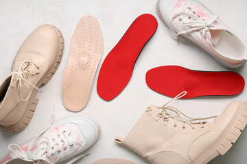 Sneakers with boots and orthopedic insoles on white background