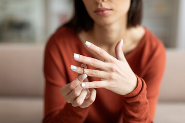 Woman taking off her wedding ring