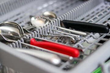 Close up of cutlery in a dishwasher