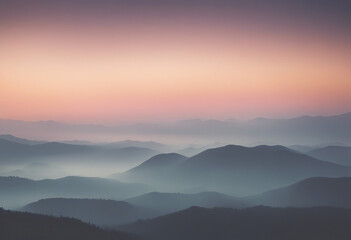 Fototapeta premium Misty sunrise silhouette over a mountain range pastel colours