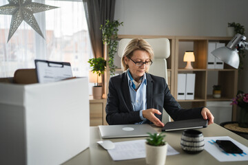 Mature woman lost her job fired from work pack personal items in box