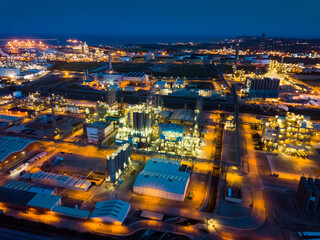 Fototapeta na wymiar Night aerial panoramic view of large chemical plant located next to Salou city, Spain