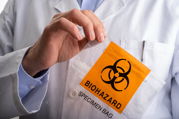 Doctor holds Biohazard Specimen Bag. Copy space. pandemic concept