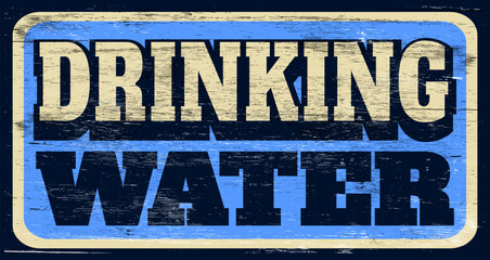 Aged and worn drinking water sign on wood