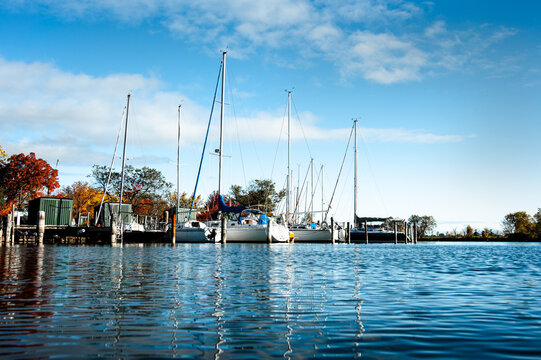 Sail boats in marina of the boat club in Belle Isle, Detroit Michigan for leisure lifestyle with a beautiful blue sky